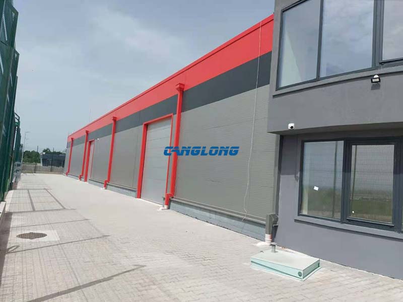 Side elevation of the steel storage warehouse along the fenced plot in Bitola