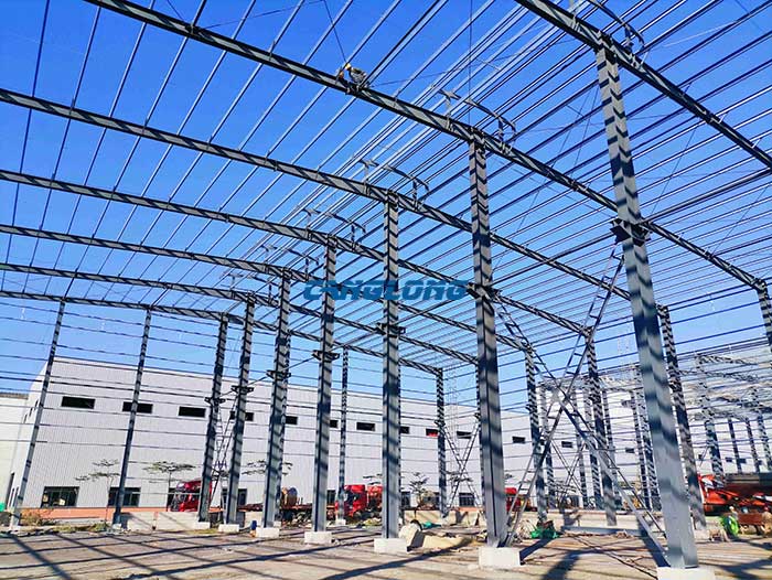 Steel frame system with rigid column and beam connections in factory construction