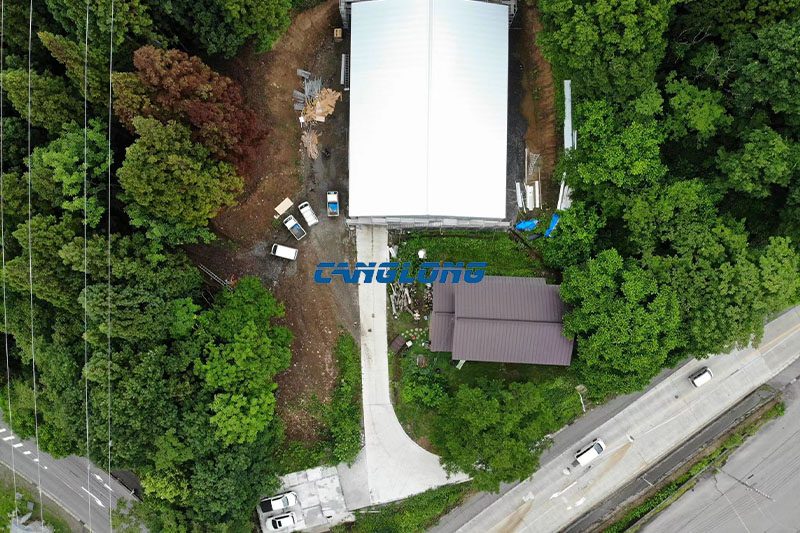 Aerial view of 28m by 21m prefabricated steel warehouse project in Japan surrounded by forest