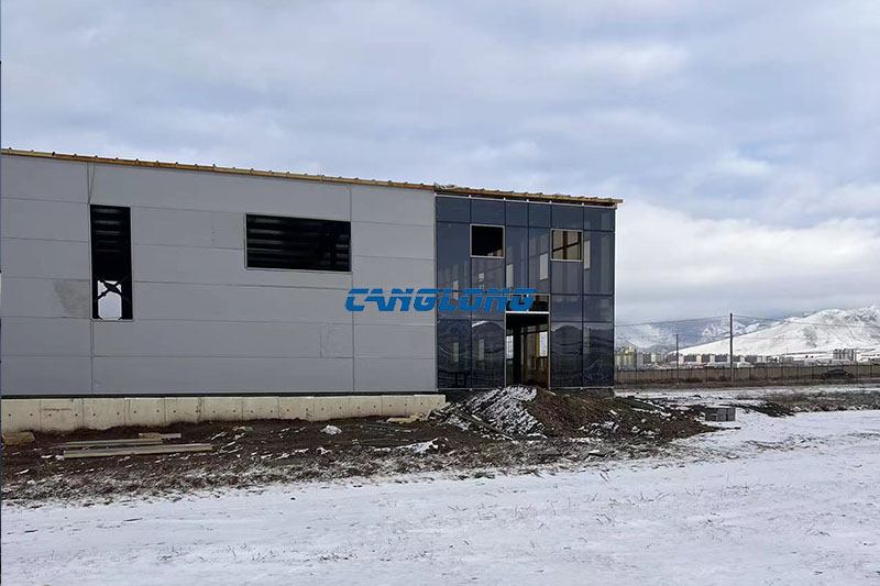 Completed steel structure mining workshop building standing on open steppe landscape outside Ulaanbaatar