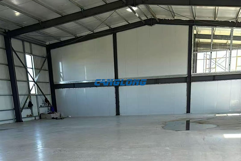 Interior view of an erected steel portal frame with mezzanine level at a mining workshop building in Ulaanbaatar
