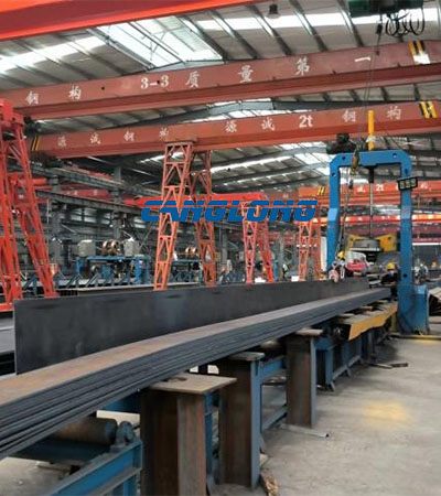 H‑beam fit‑up and assembly station, tack‑welding for portal‑frame steel members before welding