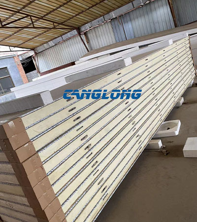 Finished PU insulated sandwich wall panels after required cooling period at Canglong panel workshop